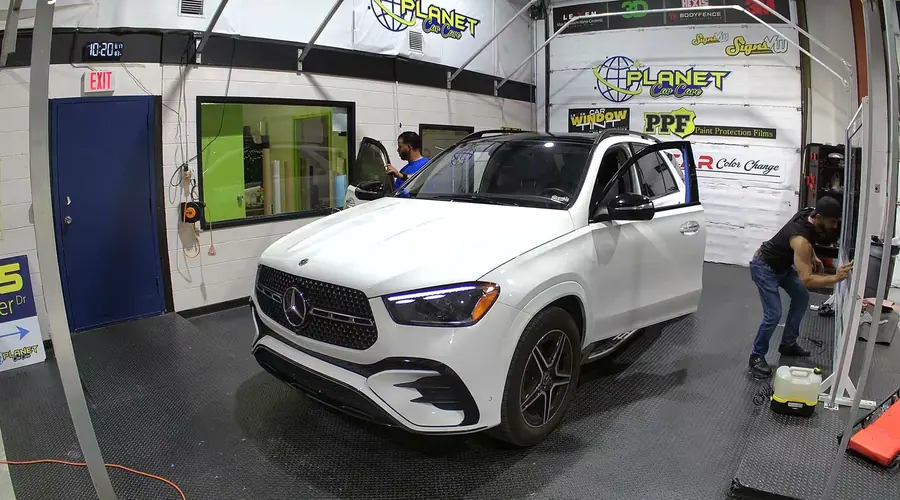 Window tint installation on a vehicle at the Signs VW shop in Orlando